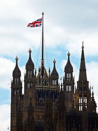Low angle view of flags against sky