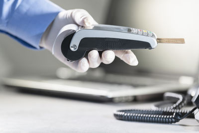 Close-up of man working on laptop