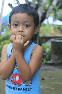 Portrait of cute boy standing outdoors