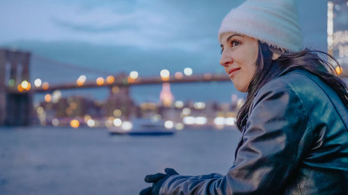 Portrait of woman against illuminated built structure