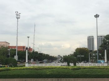 View of cityscape against cloudy sky