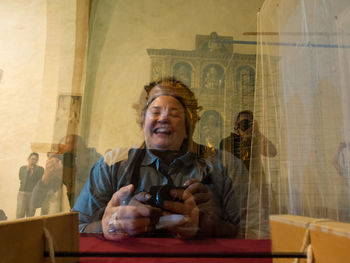Portrait of a smiling young man sitting at restaurant