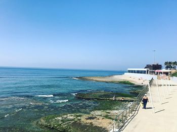 Scenic view of sea against clear blue sky