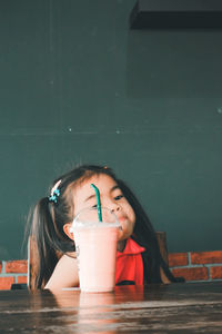 Portrait of a woman drinking water from glass