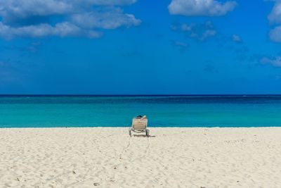 Scenic view of beach against blue sky