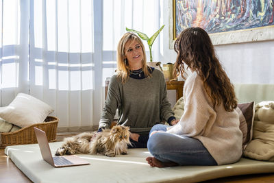 Woman sitting on sofa at home