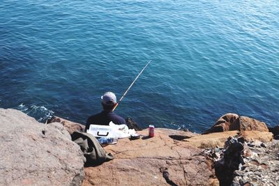 Man sitting on boat in sea