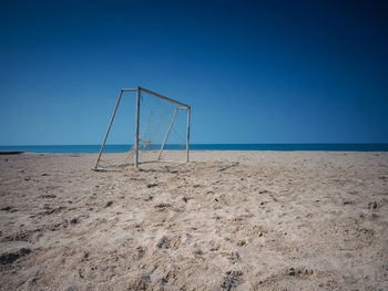 Scenic view of beach against clear blue sky