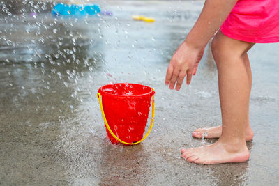 Low section of girl by splashing water