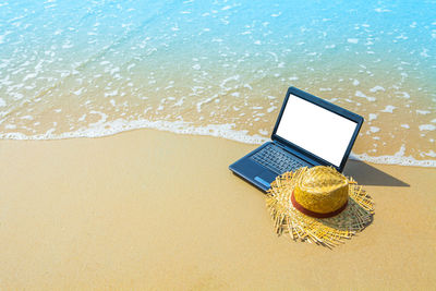 High angle view of mobile phone at beach