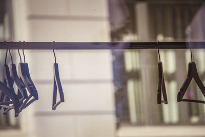 Close-up of coathangers hanging on rack