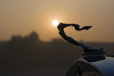 Close-up of silhouette sun against sky during sunset