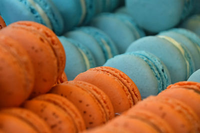 Full frame shot of orange and blue macaroons