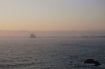 Scenic view of sea against clear sky during sunset