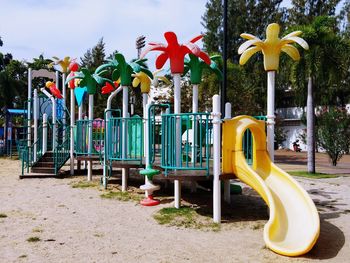 View of playground against trees in park