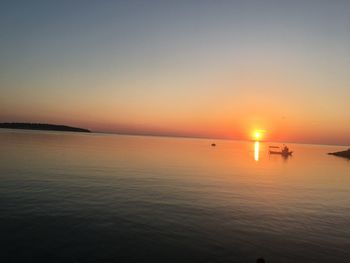 Scenic view of sea against orange sky