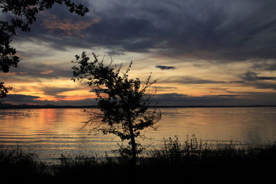 Scenic view of lake against orange sky