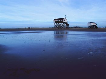 Stilt houses at wet beach