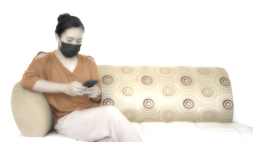 Man sitting on sofa at home