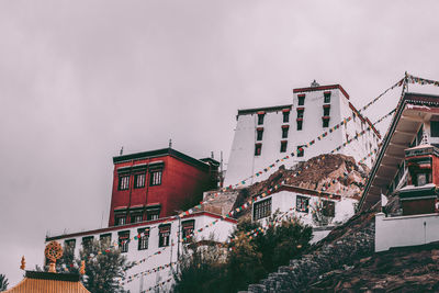 Low angle view of buildings in city against sky