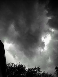 Low angle view of silhouette trees against sky