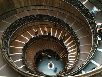 High angle view of people walking on spiral staircase