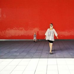 Full length of woman sitting on floor