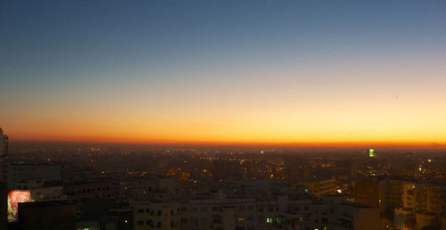 Cityscape against clear sky during sunset