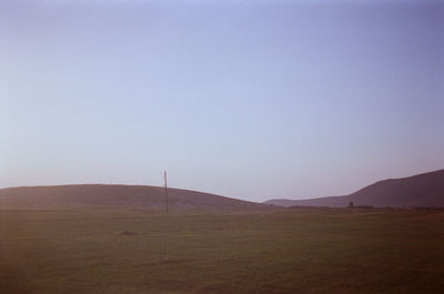 Scenic view of field against clear sky