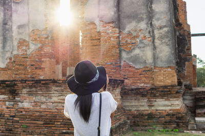 Asian female tourists taking pictures at wat phra si sanphet, phra nakhon si ayutthaya, thailand.