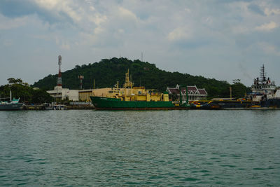 Scenic view of sea by buildings against sky