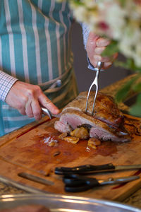 Midsection of woman having food in kitchen