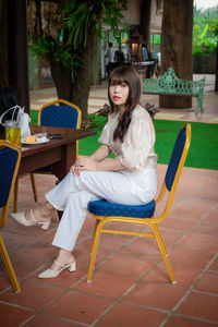 Woman sitting on chair at table