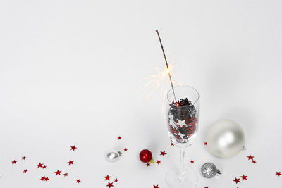 Close-up of wine glass on table against white background