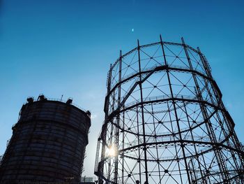 Low angle view of factory against blue sky