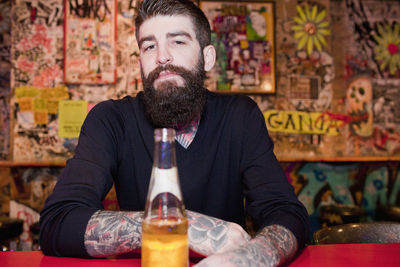 Young man drinking beer at a bar