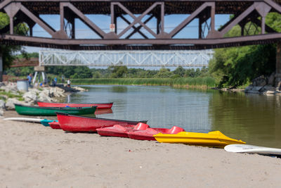 Boats moored at riverbank