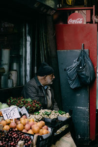 Man for sale at market stall