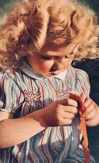 Close-up of girl holding mobile phone