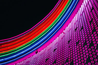 Close-up of illuminated lighting equipment against black background