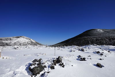 Scenic view of mountains against clear blue sky