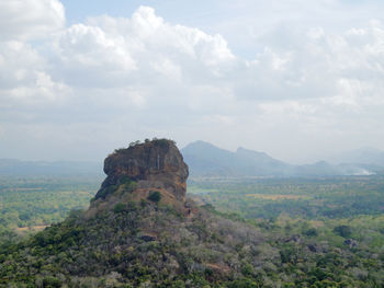 Rock formations on landscape against sky