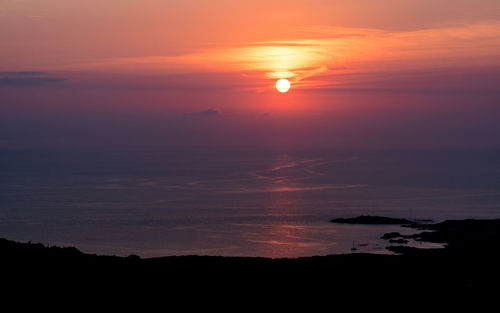 Scenic view of sea against romantic sky at sunset