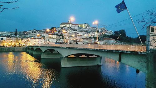 Bridge over river with buildings in background