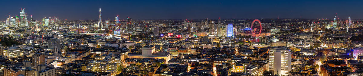 Illuminated cityscape against sky at night