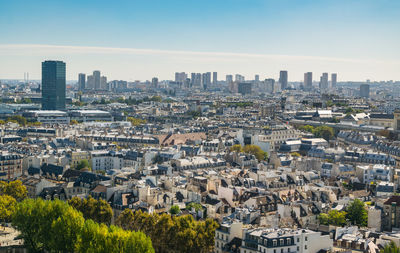  view on paris from roof of notre dame cathedral on bright sunny day