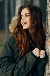 Portrait of young woman looking away outdoors