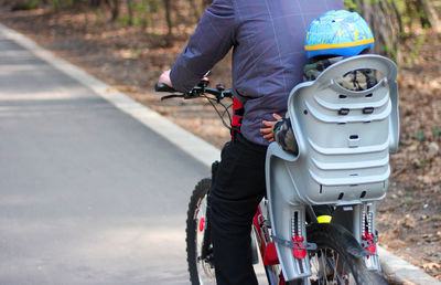 Man riding bicycle on road in city