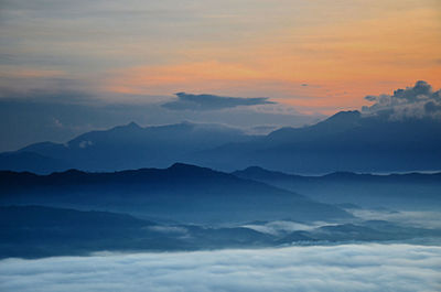 Scenic view of mountains against cloudy sky