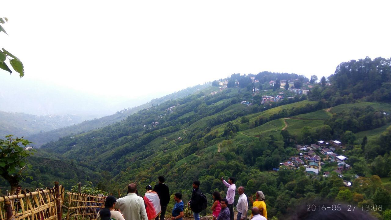 REAR VIEW OF TOURISTS ON MOUNTAIN